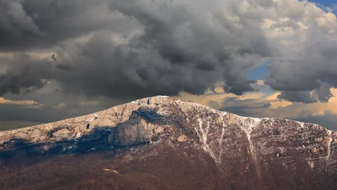 Mount top covered by a snow under dense cloudy sky time lapse scene Stock Footage 169633941