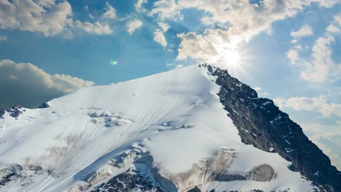 Mount top in the snow under a sparkle sun time lapse scene Stock Footage 288063563