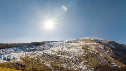 Mount top in a snow under a sparkle sun Stock Footage 321036393