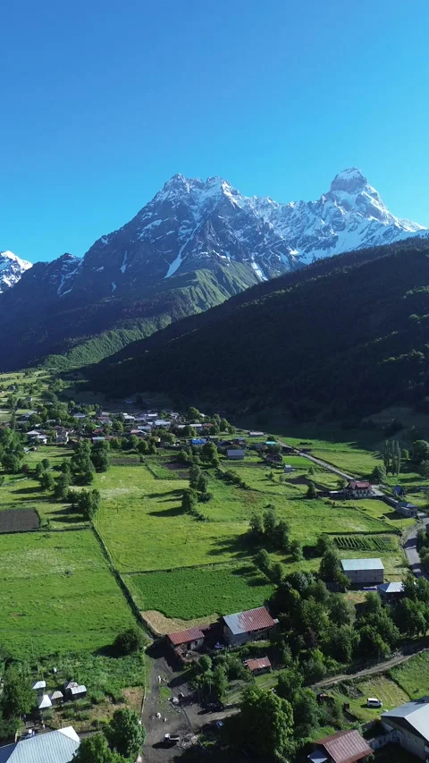 Mount Ushba Peak And Mazeri Village Vertical Drone Video 4K RAW Stock Footage 339733268
