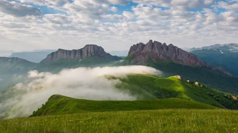 Mountain Achishboki under the ripples of clouds and fog. Stock Footage 52579733