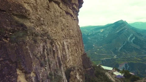 Mountain aerial flyover. Span next to the rock wall. Video stock 70265155