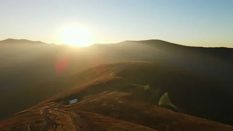 Mountain Aerial sun rays emerging though the clouds in the mountains. Mountain Stock Footage 194453191