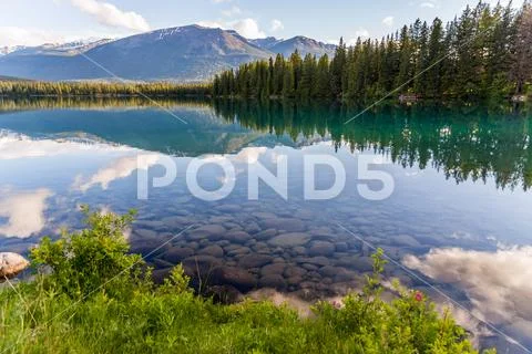 Mountain and Lake with reflection and stones Stock Photos