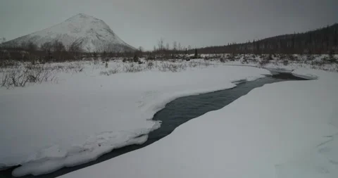Mountain and river landscape in winter in the north Stockbeeldmateriaal 323647170