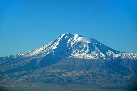 A mountain Ararat covered in snow with a blue sky in the background Stock Photos