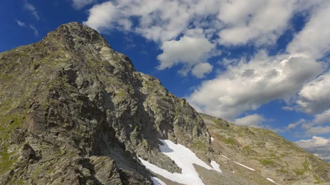 Mountain backbone on blue cloudy sky background time lapse scene Stock Footage 178925315