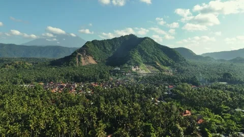 Mountain backdrop with tropical Candi Dasa Bali coastline aerial flyover Stock Footage 317169793
