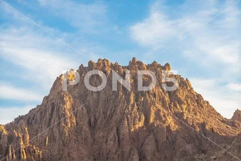 The mountain on the background of a blue sky Stock Photos