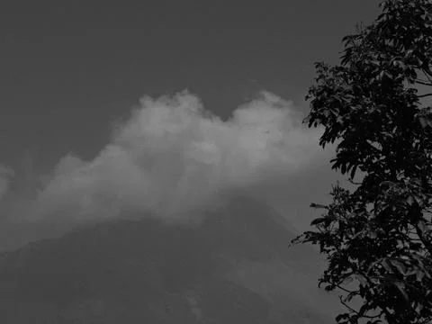 A mountain is in the background with a cloud in the sky Stock Photos