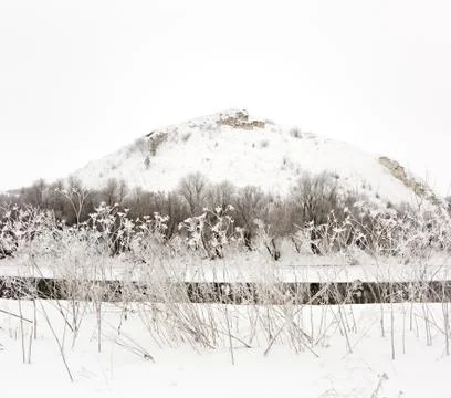 Mountain on a background of the ice river. Winter landscape in Russia. Stock Photos