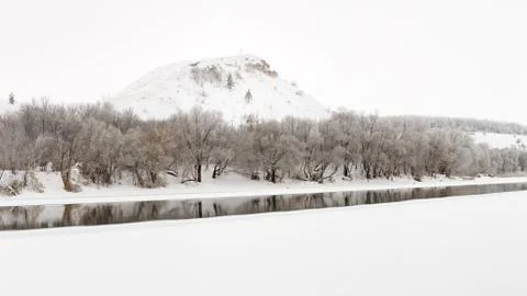 Mountain on a background of the ice river. Winter landscape in Russia. Stock Photos