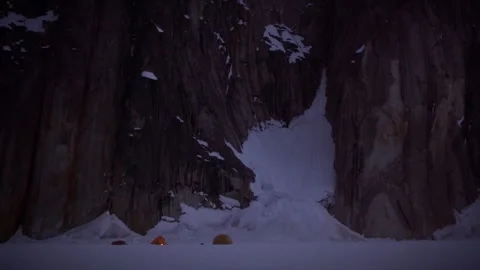 Mountain base camp with glowing tents at dusk Stock Footage 335099674