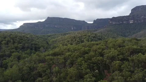 Mountain behind forested valley Video stock 239429891