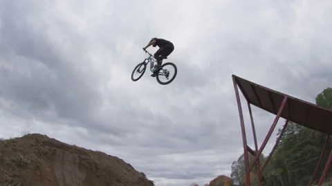 Mountain bike jumping slow motion Stock Footage 143494575