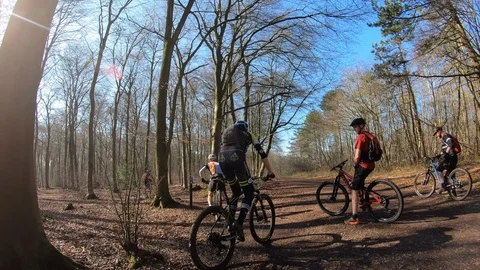 Mountain bike riders chasing on Single track over berms and jumps Stock Footage 123178300