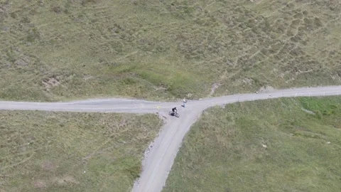 Mountain Biker and Walker Encounter at a Crossroad: An Aerial View of Choices on Stockbeeldmateriaal 344289177