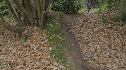 Mountain Biker around Corner- Mid Slow Camera Track Out - Shot 1 of 5 Stock Footage 63332176