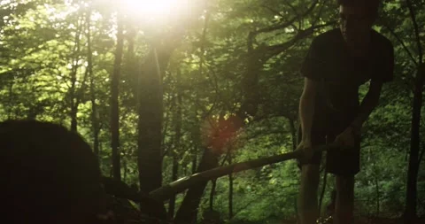 Mountain Biker Building a Jump in the Forest. Patting down Dirt with a Shovel.	 Stock Footage 133433682
