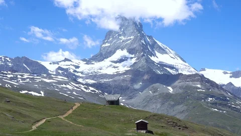 Mountain Biker Couple Talking Break in Mountains With Matterhorn Stock Footage 93310269