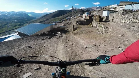 Mountain Biker Cycling Through Ancient Village In The Mountains  Stock Footage 101572963