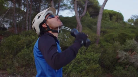 Mountain Biker drinking water in a Sunset Forest in Slow Motion Stock Footage 260260451