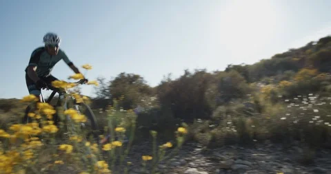 Mountain biker driving over a mountain trail Stock Footage 129884548