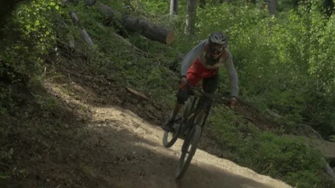 Mountain Biker Going Off Jump In Slow Motion Front View 库存影片 73499774