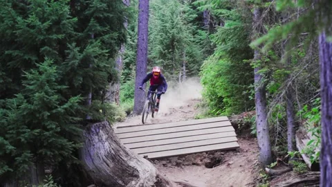 Mountain Biker- Going over ramp Stock Footage 140942353