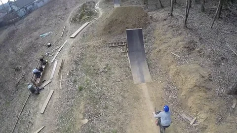 Mountain biker hits the drone with a back wheel while doing a backflip, 4K Stock Footage 73856962