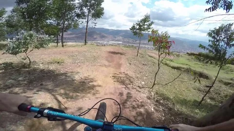 Mountain Biker Jumps Over A Gap With Big Mountain Views Video stock 79701090