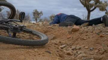 A mountain biker just after a fall on a desert trail Stock Footage 85854552