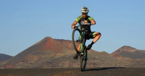 A Mountain Biker Pulls a Wheelie. 스톡 동영상 79821716