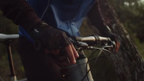 Mountain Biker puts his hands in a handle bar in Slow Motion Stock Footage 260260355