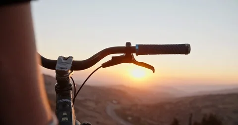 Mountain biker putting his hands on bicycle wheel, ready to go down the mountain Stock-Footage 100619060