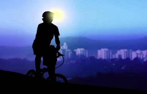 Mountain biker resting while watching sunrise Stock Photos
