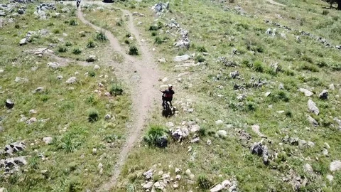 Mountain biker riding down a biking trail Video stock 98955351