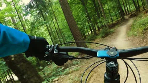 Mountain biker riding on flow single track trail in green forest. Stock Footage 138743861