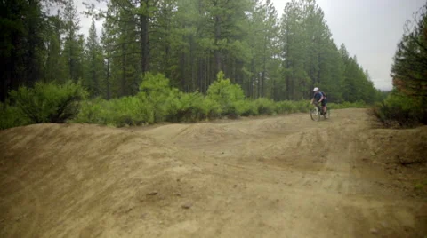 Mountain biker on rough dirt road trail Stock Footage 59538366