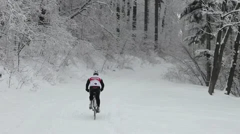 Mountain biker in snow Stock Footage 21324514