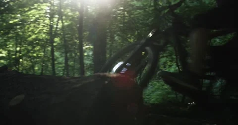 Mountain Biker taking a High Jump. Jumping over an Obstacle. Riding through a Fo Stock Footage 133433467