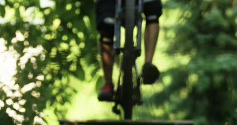 Mountain Biker taking a High Jump. Jumping over an Obstacle. Riding through a Fo Stock Footage 133434064