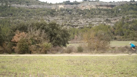 Mountain biker through a mountainous landscape Stock Footage 124522186