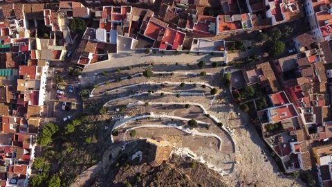 Mountain bikers climbing zig zag slopes in a village in Spain Stock-Footage 160755999