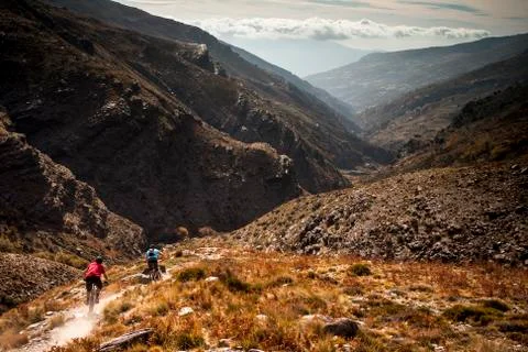 Mountain Bikers in a desolate valley Stock Photos