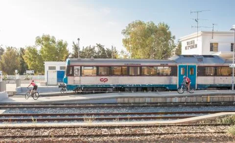 Mountain bikers getting down from train at railway station Stock Photos