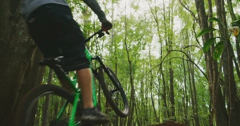 Mountain bikers jumping high into the air in slow motion Stock Footage 119008290