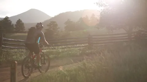 Mountain bikers ride into sunset Stock Footage 50961311