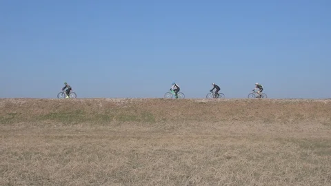 Mountain bikers on the riverside path Stock Footage 122883374