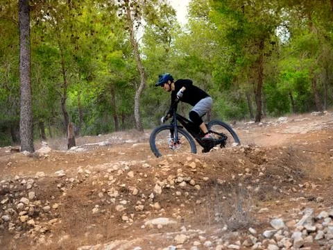 Mountain bikiing in a forest Stock Photos